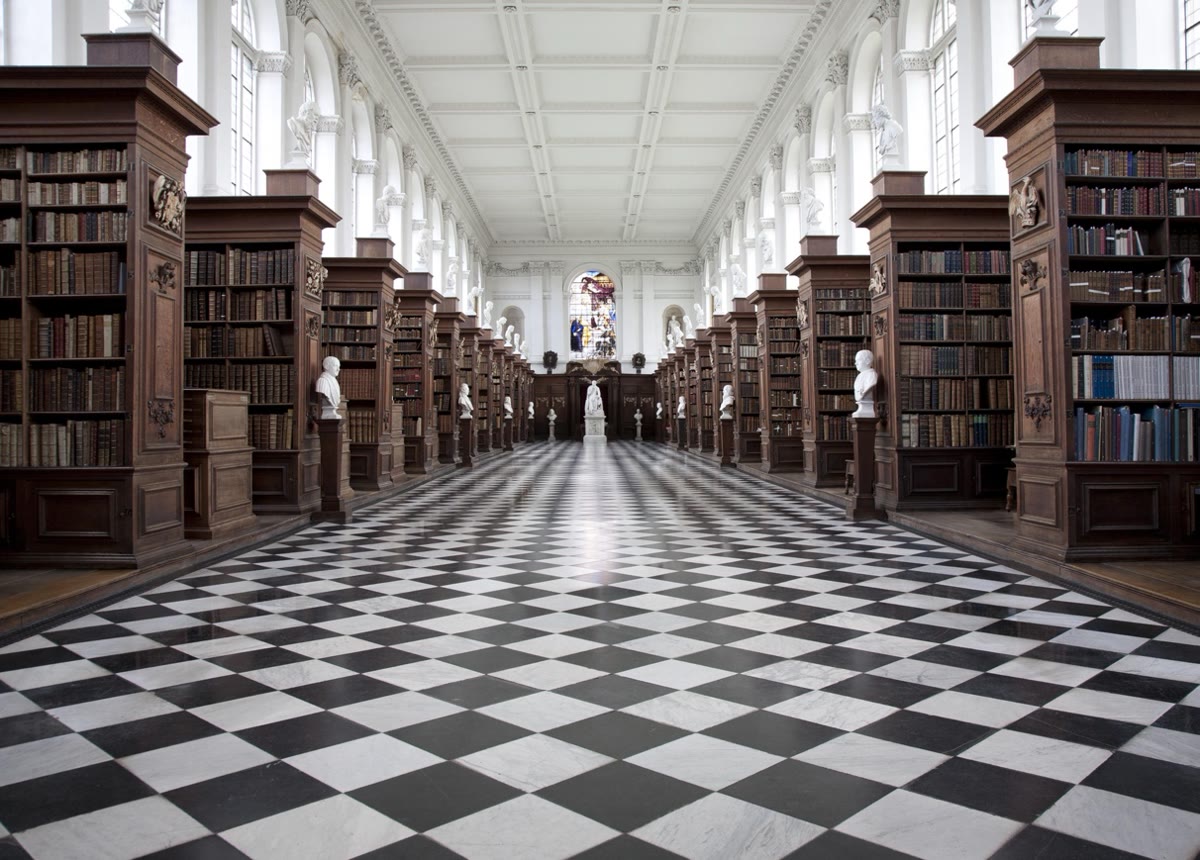 The interior of the Wren Library, Trinity College: long bookcases on a chequered floor