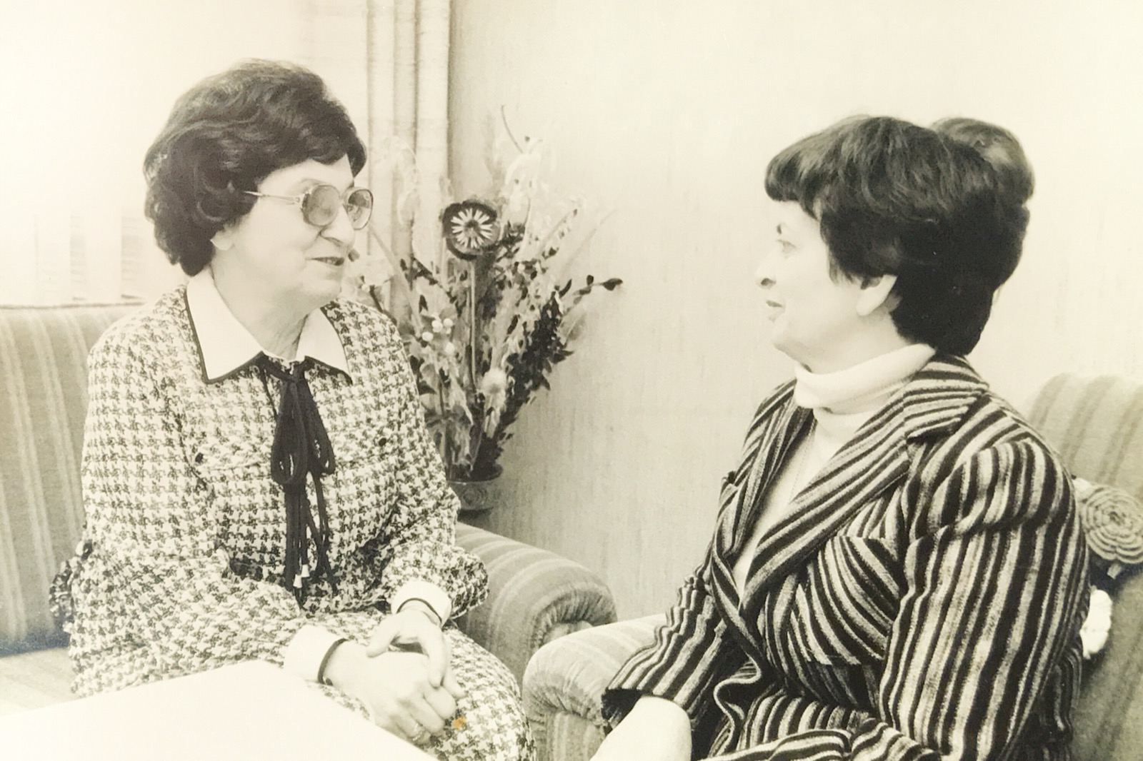 Photograph of Elka and Hildegard, older, seated together in conversation