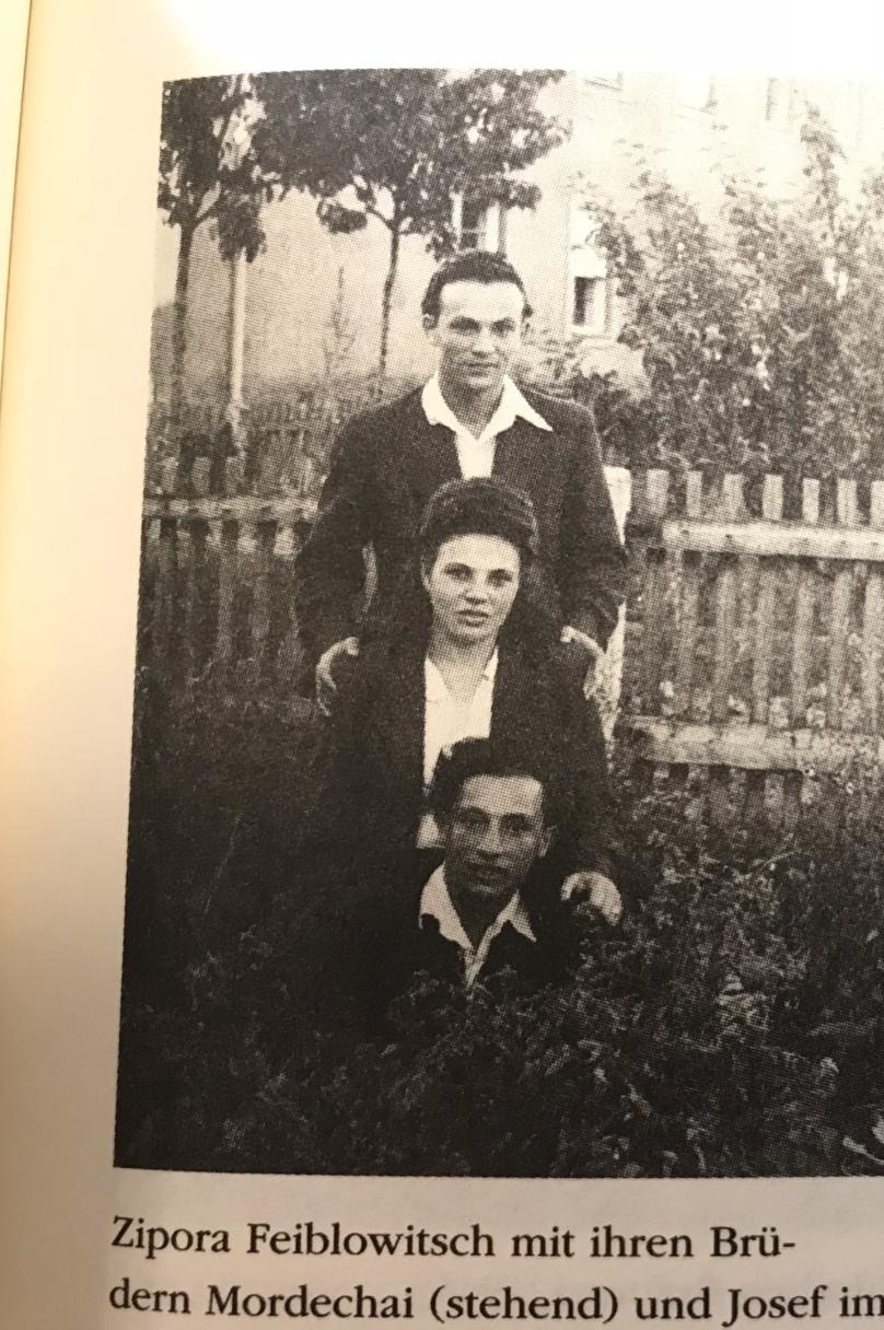 Archival photograph: Zippora with her brothers Mordechai, standing, and Josef, in a garden